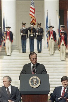 President George H.W. Bush addresses the nation's governors at the University of Virginia in Charlottesville, Va., on Sept. 29, 1989, at the conclusion of the two-day education summit. At left is Education Secretary Lauro Cavazos and at right is Iowa Governor Terry Branstad.