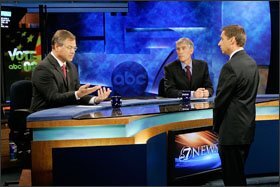 Republican Bob Schaffer, left, and Rep. Mark Udall, center, a Democrat, discuss debate rules with KMGH-TV News Director Jeff Harris in Denver on Oct. 16. They are seeking an open U.S. Senate seat from Colorado, and have discussed the No Child Left Behind Act.