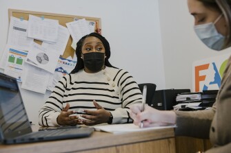 Jenna Monley, deputy chief of family and community engagement at Philadelphia Public Schools, meets with Assistant Director Lauren Rowland at the Philadelphia School District offices in downtown Philadelphia on December 15, 2021.