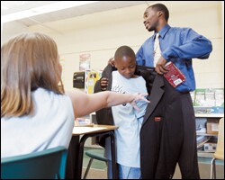 Thrid grader Chase Smith is rewarded for a correct answer by getting to wear Hayward Jean's jacket for 30 minutes during class. Jean's students have been known to copy their teacher's formal attire by wearing their Sunday best to school. Asked about the youthful teacher, one student says Jean "is not boring or dull."