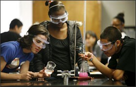 From left, students Jon Martin, Courtney Griffin, and Luis Calvillo work on a titration experiment in a chemistry class at Lanier High School.