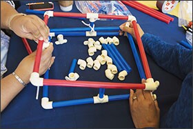Teachers in the Flagstaff teacher training facility work on design projects, like this portable livestock corral model.