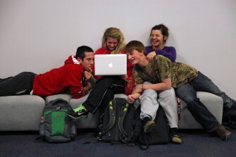 Juniors Kyle Copple, left, Caitlin Williams, Rex Whisner, and Amber Rutledge, take a break between classes at the campus. The Joplin school district handed out 2,200 Apple MacBooks to all its high school students on the first day of school, just 87 days after a violent tornado devastated the community.