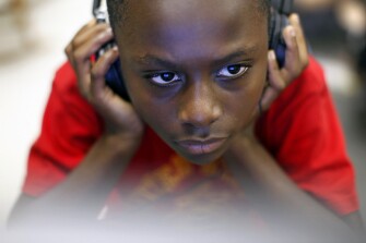 Maurice Van Lowe, a 4th grader at Burning Tree Elementary School in Bethesda, Md., reads in his classroom using Bookshare, a nonprofit electronic service that more quickly converts books into more accessible formats for students with certain kinds of disabilities. The service turns books into a format that can be read aloud by computers, magnified, and spaced differently.