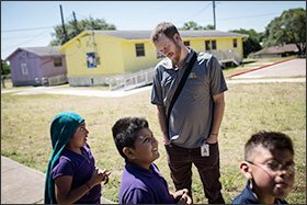 Butler, the Austin school system’s mindfulness director, chats with students on his way to Andrews Elementary School. Climate measures improved dramatically in district schools that piloted the mindfulness curriculum that Butler developed.
