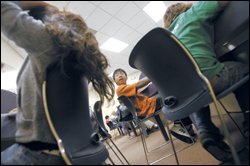 Alexander Tran, 13, center, talks to his classmates during a recent tutoring session at the Huntington Learning Center in Woodland Hills, Calif. The student is one of the thousands in the Los Angeles Unified School District taking advantage of the free help under the federal No Child Left Behind Act. But many more are eligible.
