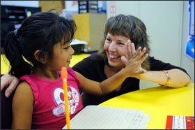 Sherry Comer, the director of after-school services for the Camdenton, Mo., school district, greets kindergartner Bernice Gopar during a program for English-language learners in the sparsely populated community.