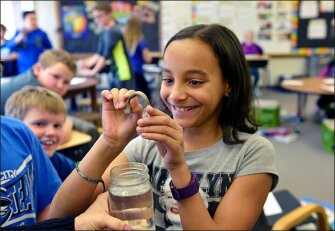 Fourth grader Sameern Malcom bends a vinegar-soaked turkey bone in a health class demonstrating the value of bone calcium at Washington Elementary School in Valley City, N.D. The school earns kudos for sticking with programs such as nutrition, physical education, and the arts that sometimes lose out to budget pressures.