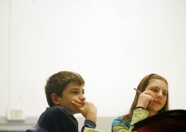 Fifth-grader Jordan Claflin, left, and 6th grader Chirara Fritsch attend class at Anser, whose leaders hope to buy a different facility from the Boise district.