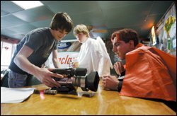 Chris Hergert, the winner of a recent student-film competition in Texas, shows a clip to actors working on the set of a new movie in San Antonio.