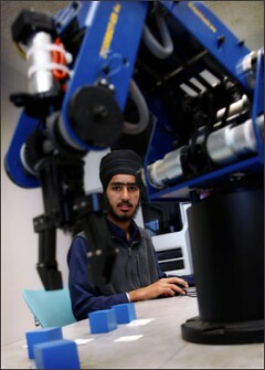 Satwant Singh, a student at Harmony Magnet Academy, works with robotics to stack blocks into a pyramid during a computer class. The engineering pathway at Harmony is one of nine career pathways developed by the Porterville Unified School District to more closely link academics with students’ career interests.