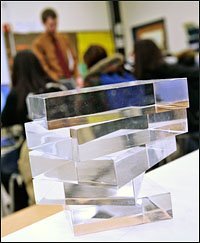 Matthew Anthes-Washburn uses everyday items for lab experiments in his classes. Plexiglas blocks illustrate the principle of refraction in a physics lesson about optics.