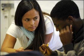 Mathematics teacher Tiffany Clements helps 9th grader Ja’ Vonte Richie at The Academy @ Shawnee. Teachers say students are getting used to the higher expectations.