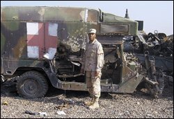 Mr. Slater poses by a damaged ambulance last year near his base in Balad.