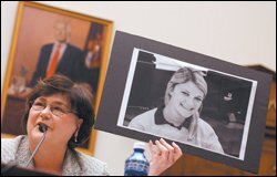 Doris Voitier, the superintendent of Louisiana's St. Bernard Parish school district, holds a photo of a student affected by Hurricane Katrina during a House hearing.