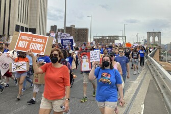 Demonstrators calling for gun control march across the Brooklyn Bridge, on June 11 in New York.
