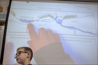 Second grade student Cole Mason shows his work to his classmates at Gregory Heights Elementary School. An influx of new classroom technology is driving the push for greater interoperability.