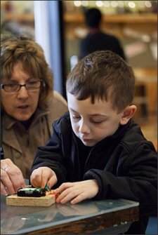 Paula Kislock and her grandson, Cooper Wilson, 5, work with electric-based projects in the Children's Museum of Pittsburgh's "Makeshop" earlier this week.