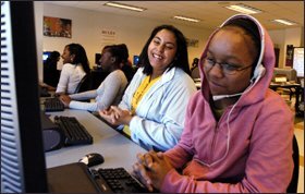 Seventh graders Alexis Seeney, right, and Alexa Bumpass laugh at their video mix while working on their science video.