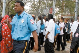 As the school day ends recently at John McDonogh High School in New Orleans, security guards keep a watch on students.