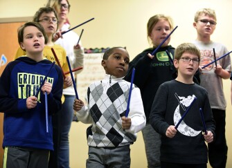 Students work with rhythm sticks during a 5th-grade music class at Washington Elementary School.
