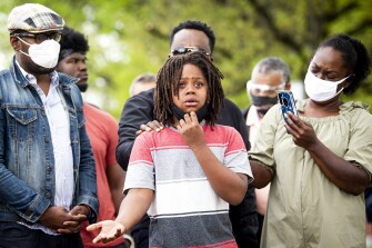 Simeon Jones, 12, cries as he speaks to a group gathered for a vigil in front of Austin-East Magnet High School in Knoxville, Tenn. on April 13, 2021. The shooting comes as the community reels from off-campus gun violence that has left three other students dead this year.