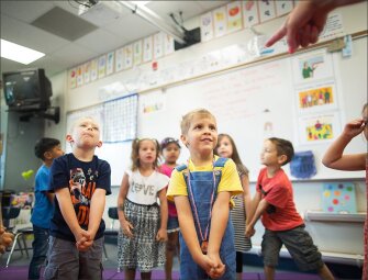 Tyler Johnson, center, is picked to choose the next lesson during a KITS class.