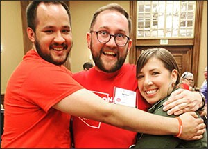 From left to right, #RedForEd supporters Dylan Wegela, Derek Harris, and Rebecca Garelli celebrate their pay-raise victory in Scottsdale, Ariz. earlier this month.