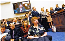 An overflow crowd observes a House-Senate conference on Nov. 17.