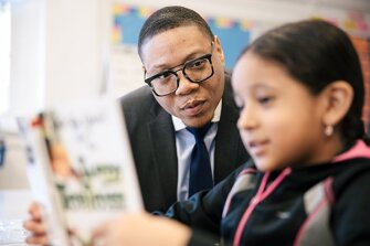 District of Columbia Public Schools Chancellor Lewis Ferebee sits in on a 3rd grade class at Bruce Monroe with student Estafani Martinez Jurado.