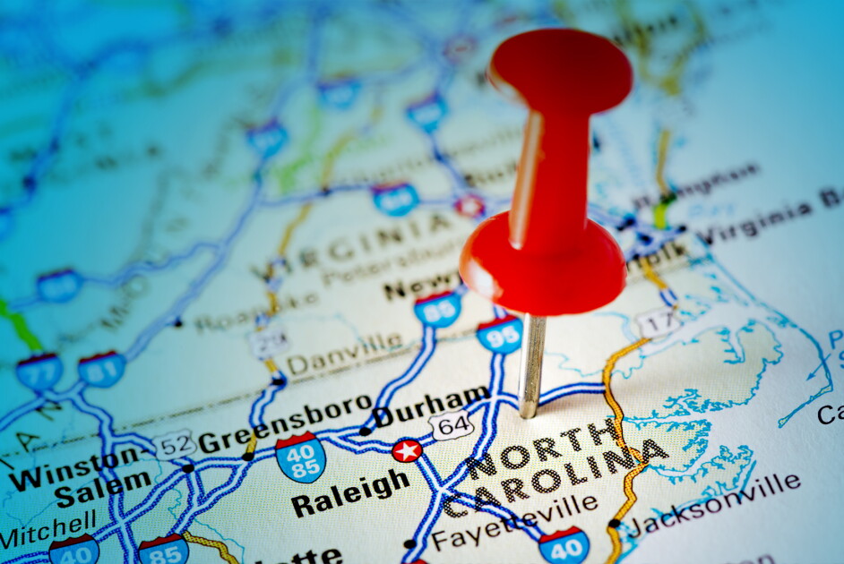 Red Thumbtack Over North Carolina State USA Map.