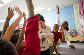 Teacher Mary Godfrey leads 4th grader Maliyah Rogers, far right, and 5th grader Dynasti Gunn in making fruit smoothies in the Pathways Girl Scout program at Corning Achievement Elementary School in Memphis. The school is part of the state-run Achievement School District.