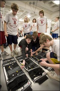 Students at Naperville Central High pick out heart-rate monitors and watches at the start of a typical physical education class, above. They are instructed to keep their heart rates between 160 and 180 beats per minute for at least 15 minutes.