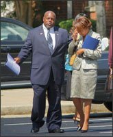 State Rep. Mike Glanton tries to calm Clayton County school board member-elect Jessie Goree after an Aug. 28 meeting in Decatur, Ga., where they learned the Clayton County schools would lose their accreditation.