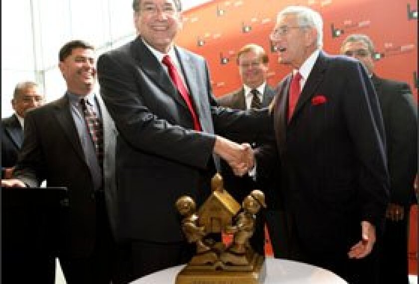 Eli Broad, right, congratulates Hector Gonzales, the superintendent of the Brownsville, Texas, school district, which won the Broad Prize for Urban Education. The district will receive $1 million in college scholarships for graduating seniors.