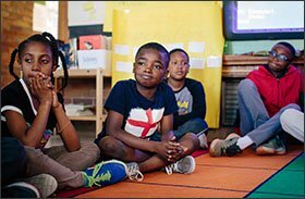 Students Oluwanifemi Ikhana, center, and Breana Campbell listen to a 4th-grade classmate classmate talk about how he works through emotional situations in his life during class at Oakton Elementary School in Evanston, Ill. —Alyssa Schukar for Education Week