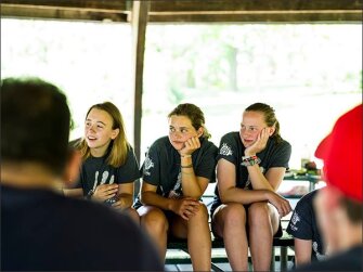Mount Horeb high school students, from left, Kate Kuse, a junior, and sophomores Maggie Kelley and Kenzie Coulthard listen as Kaleka and Michaelis share their stories during last month’s gathering in Mount Horeb.