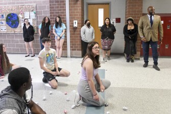 Principal Michael C. Brown, right, watches a U.S History lesson where students are demonstrating line warfare at Winters Mill High School in Westminster, Md., on May 17, 2022.