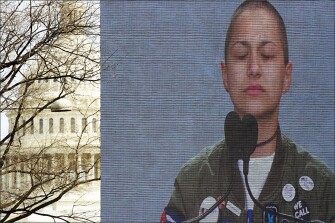 With the U.S. Capitol behind the stage, Marjory Stoneman Douglas High School student Emma Gonzalez is seen on a video screen as she stands silently at the podium at the “March for Our Lives” rally in Washington. The silence marked the amount of time that ticked by during the massacre.
