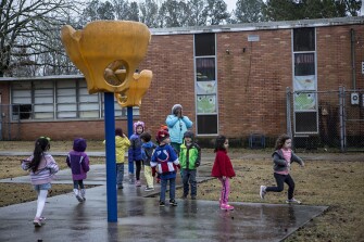 Robin Malone calls for her preschool students to come in from recess at Starkville Early Learning Collaborative.