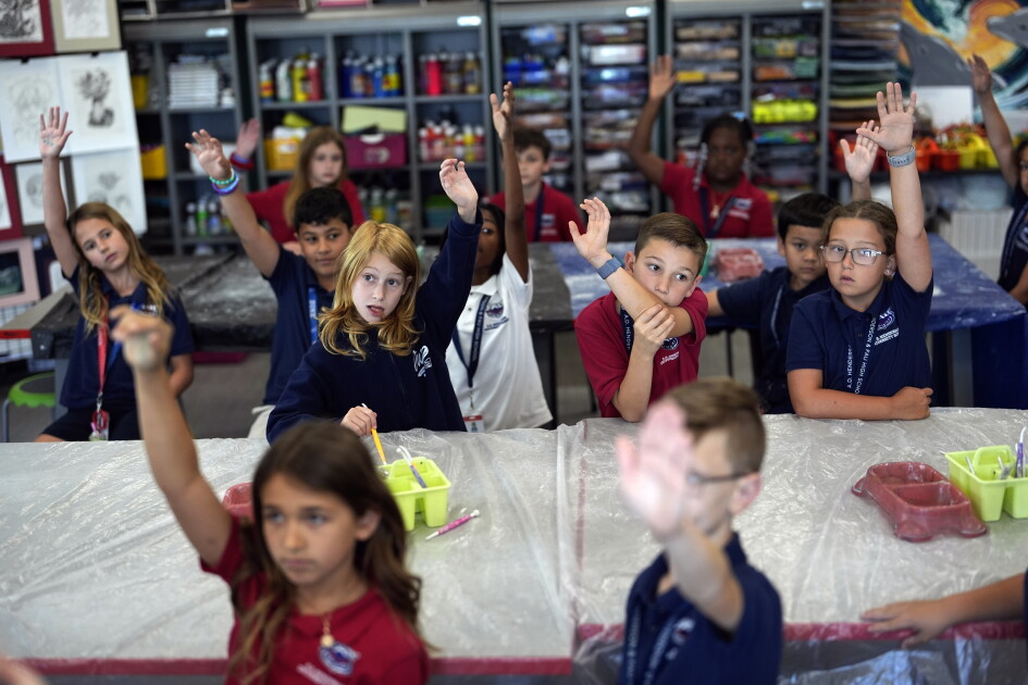 Students raise their hands in Lindsey Wuest's Science As Art class at A.D. Henderson School in Boca Raton, Fla., Tuesday, April 16, 2024. When teachers at the K-8 public school, one of the top-performing schools in Florida, are asked how they succeed, one answer is universal: They have autonomy.