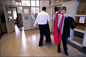 Academy @ Shawnee principal Dr. Keith Look fumbled with his robe and sash before leading a parade of seniors through the halls of the school on May 31.
