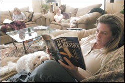 Laurie Taylor reads a novel while her daughters Hannah, 12, left, and Emmy, 14, tackle their own books during the family’s daily reading time. The Fayetteville, Ark., mother last year questioned the presence of certain books, many dealing with sex education, in her school district’s middle and high school libraries