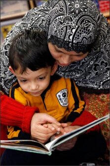Mahmuda Khatun, from Bangladesh, reads to her son Marzuq Rashid, 3, at the Parenting and Family Literacy Center in Crescent Town Public School in the Toronto school district. The center helps equip parents with the skills necessary to prepare their children for school.