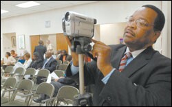 Ronald E. Jackson, the executive director of Citizens for Better Schools in Birmingham, Ala., prepares to address his city’s school board last week. The group is pressing for stronger federal enforcement of the No Child Left Behind Act’s school choice provision.