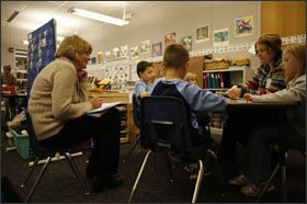 Literacy coach Nancy McLean, left, takes notes while observing 1st grade teacher Charity Haviland working with students on a reading lesson at North Star Elementary.