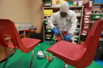 Servepro employee Joseph Felks cleans chairs and other items at Joyner Elementary School in Tupelo, Miss., on March 11, 2020, as the Tupelo Public School District conducts a cleaning of all its campuses to help combat the spread of the coronavirus while the students are on spring break.