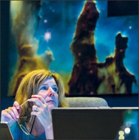 Lynn-Steven Engelke of the Smithsonian Institution monitors presentations on a projector at the Space Telescope and Science Institute in Baltimore. Cultural institutions are among those helping teachers use technology.