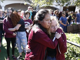 Attendees comfort one another at a vigil on Feb. 15 at the Parkland Baptist Church in Parkland, Fla., for the victims of the shooting at Marjory Stoneman Douglas High School.