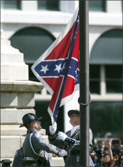 An honor guard from the South Carolina highway patrol removes the Confederate battle flag from the Capitol grounds in Columbia, S.C., on July 10, ending its 54-year presence there.